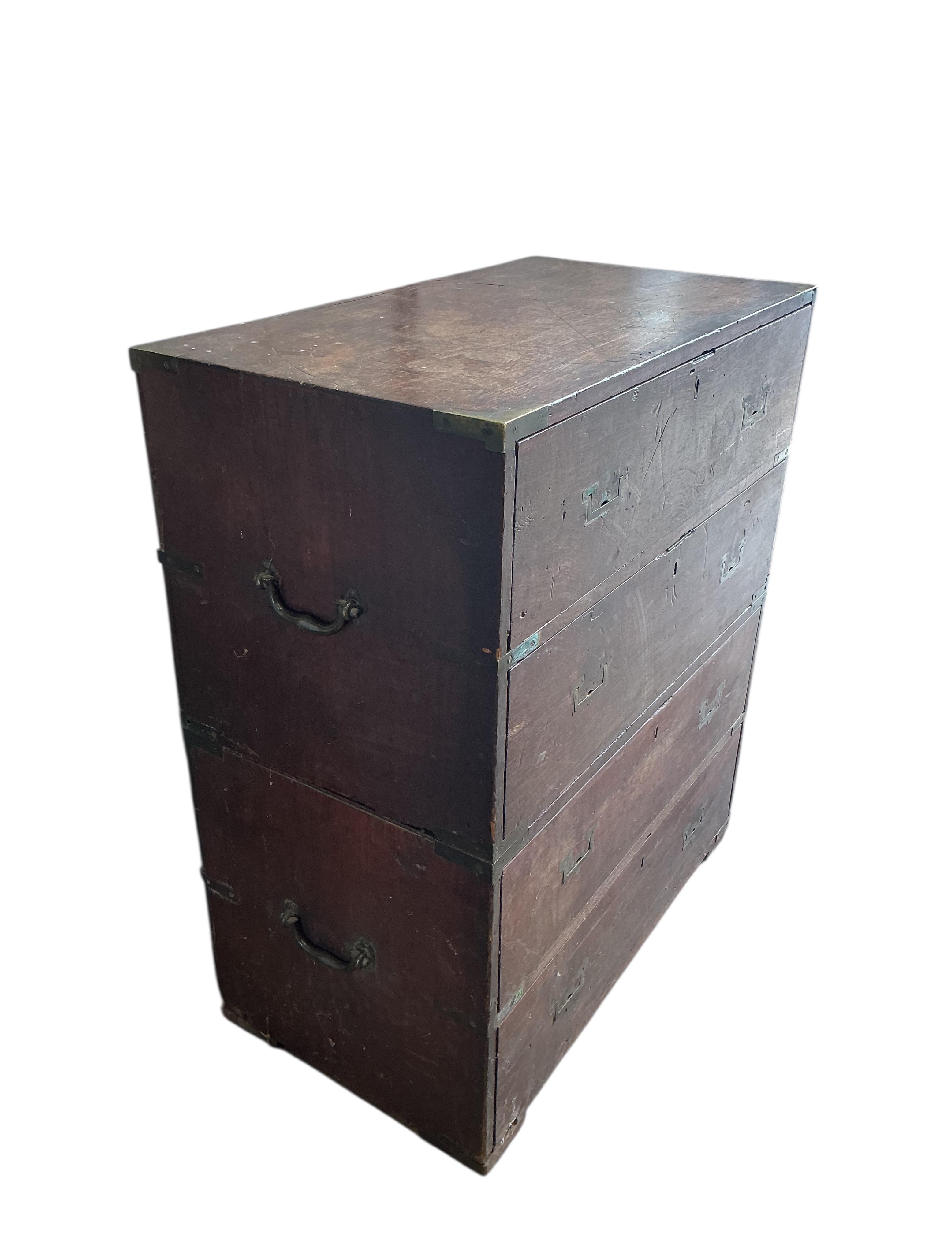 A small early 19th century teak two part campaign chest, the back with stencilled name, Mrs Nepean, width 81cm, depth 46cm, height 95cm